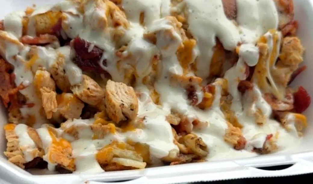 Fried taters loaded with chopped chicken, bacon and cheese under a ranch drizzle